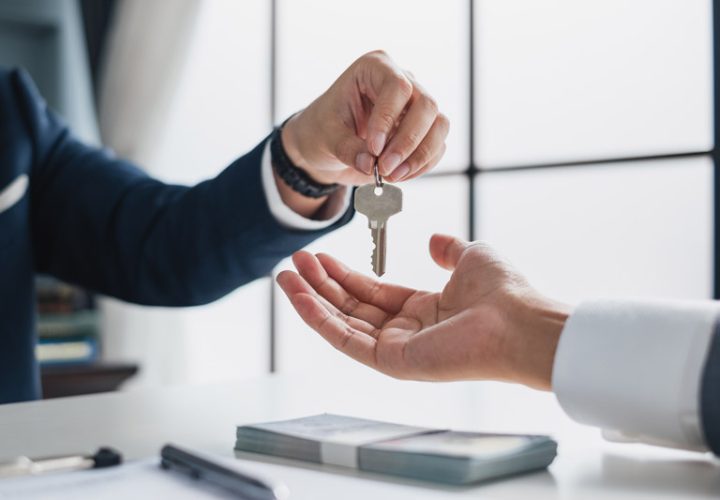 a business owner handing the key of the house to a tenant